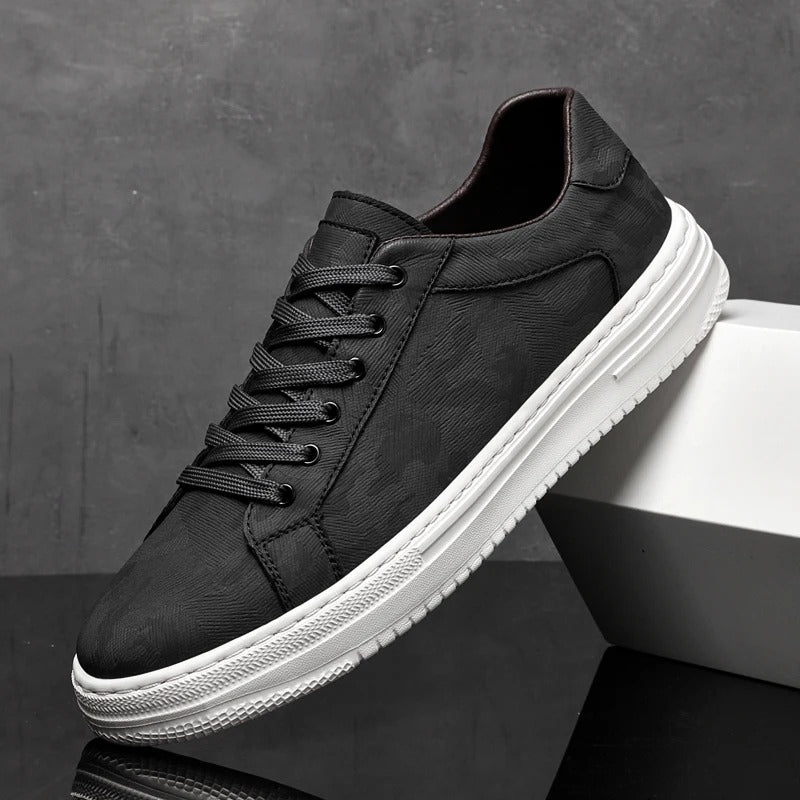 Black sneaker with white sole on a dark surface