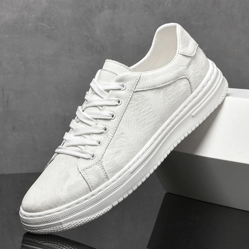 White sneaker on a dark surface with a gray background