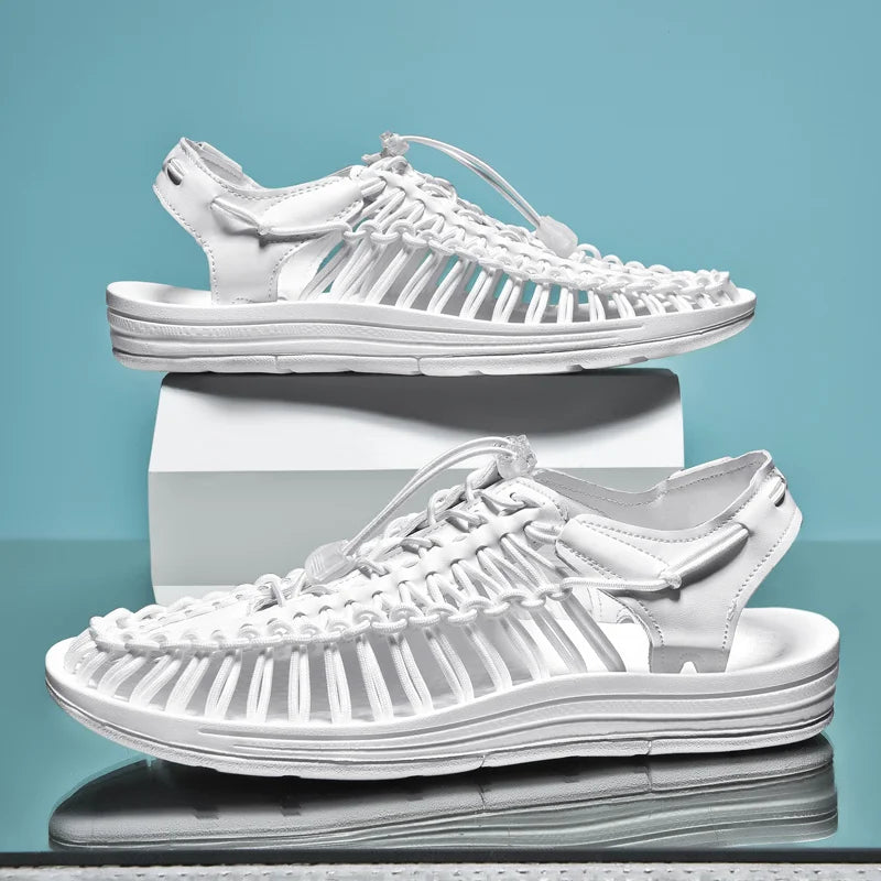 White sandals stacked on a reflective surface with a blue gradient background