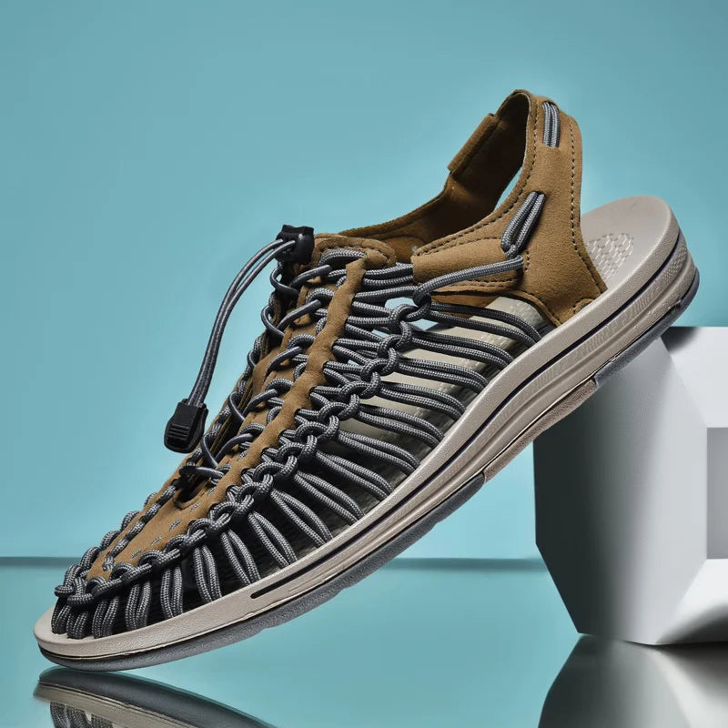 Brown and gray sandal on a reflective surface with a blue gradient background