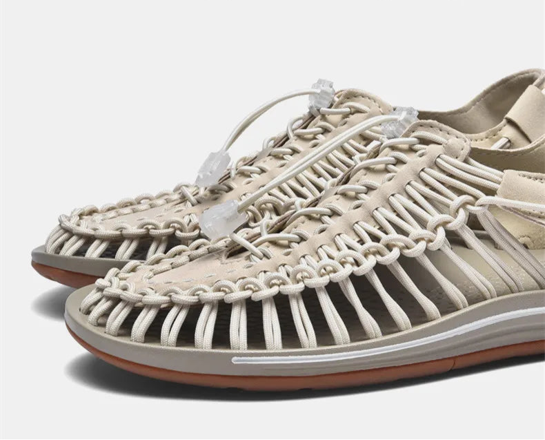 Beige woven sandals with white laces on a light gray background