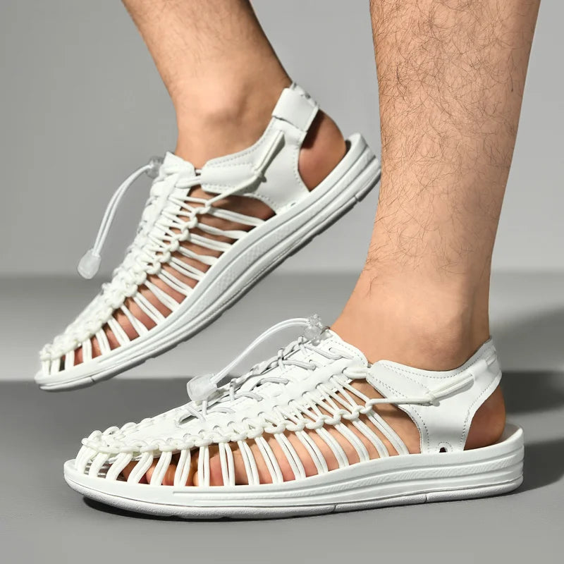 White woven sandals worn by a person on a gray background