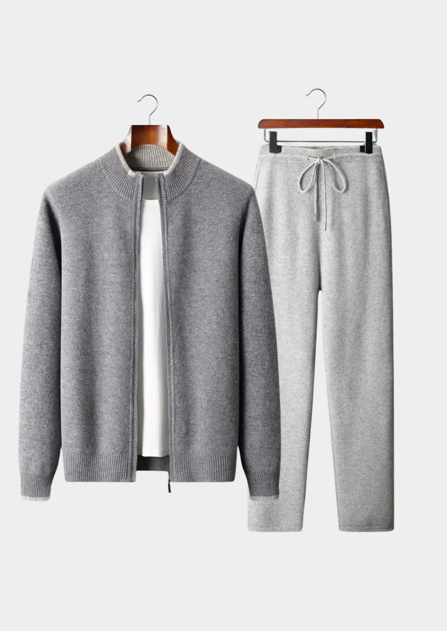 Gray cardigan and pants set on hangers against a white background