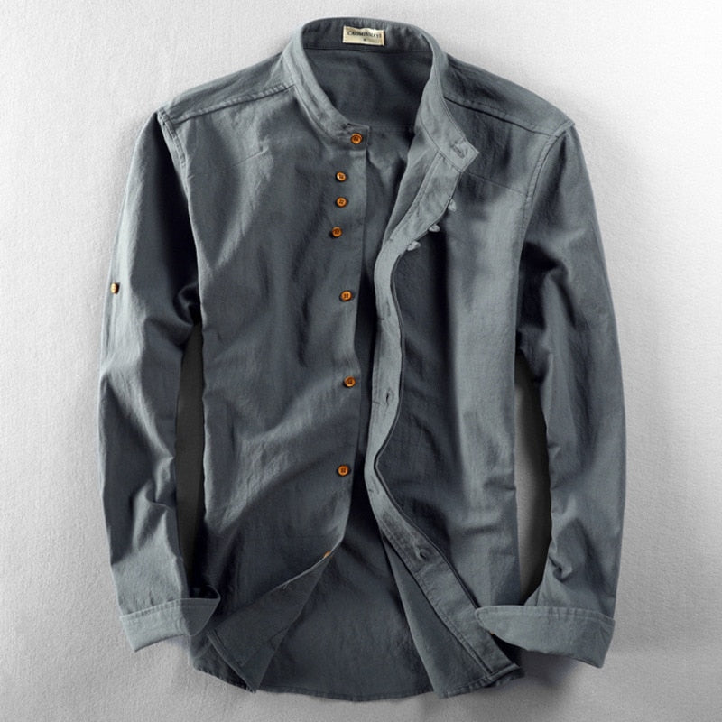 Gray shirt with rolled-up sleeves on a light gray background