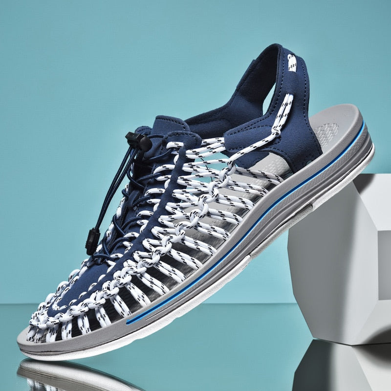 Blue and gray sandal on a stand with a blue background