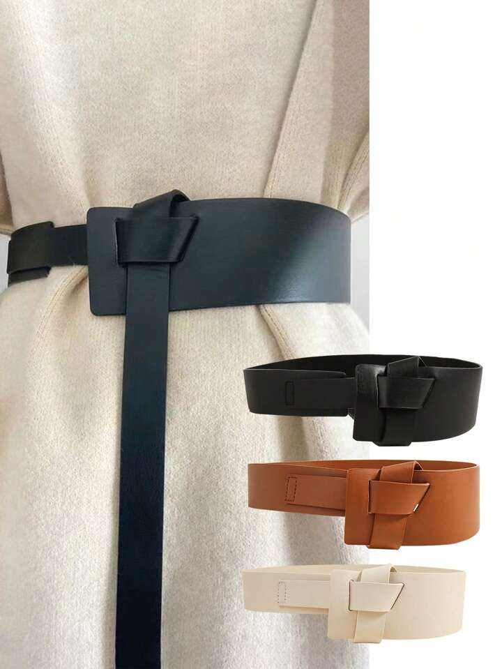 Set of three belts in black, brown, and beige on a neutral background