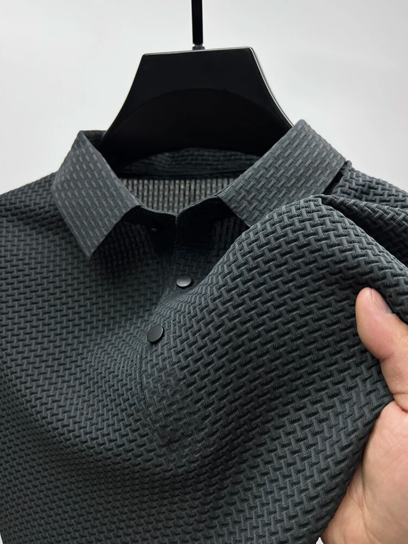 Dark gray textured shirt on a hanger with a hand holding it