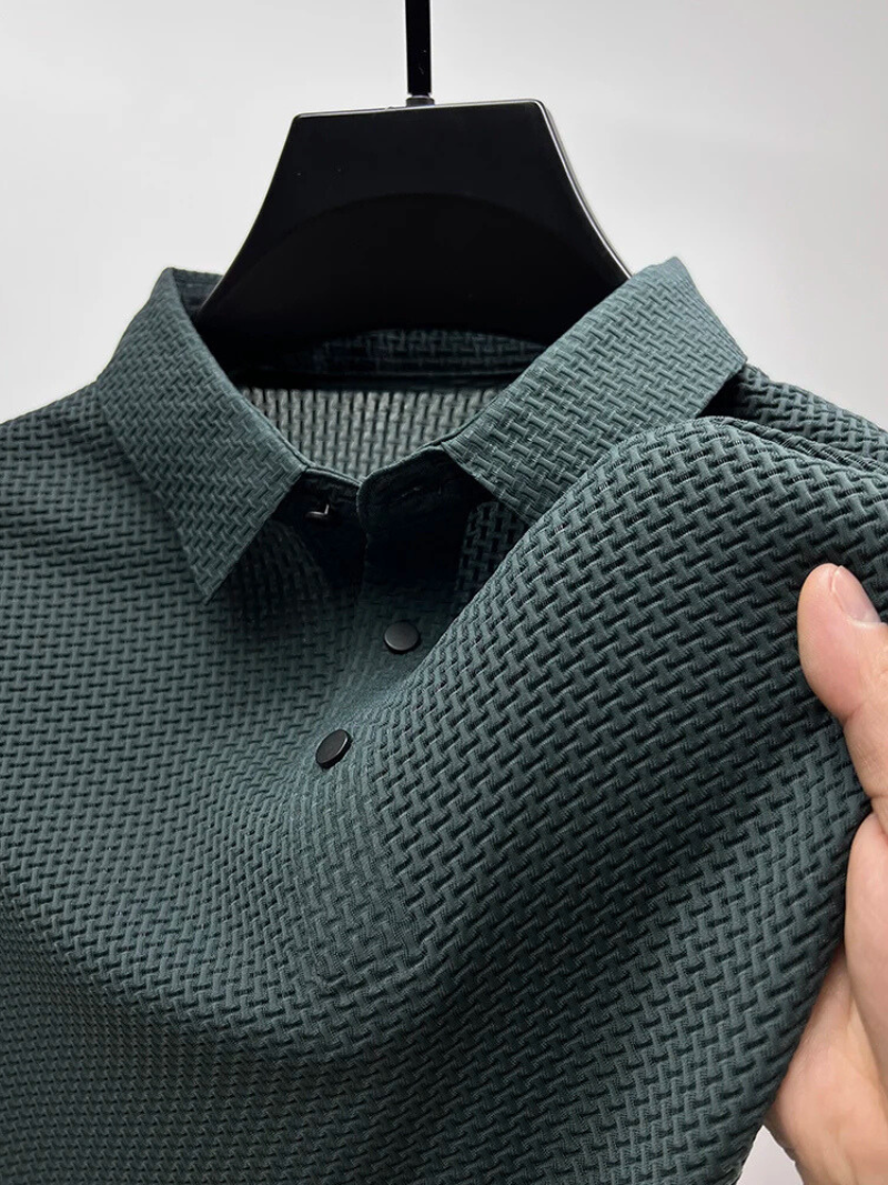 Green textured polo shirt on a hanger against a gray background