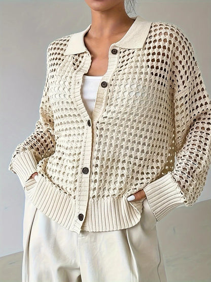 Beige knitted cardigan worn by a person on a plain background