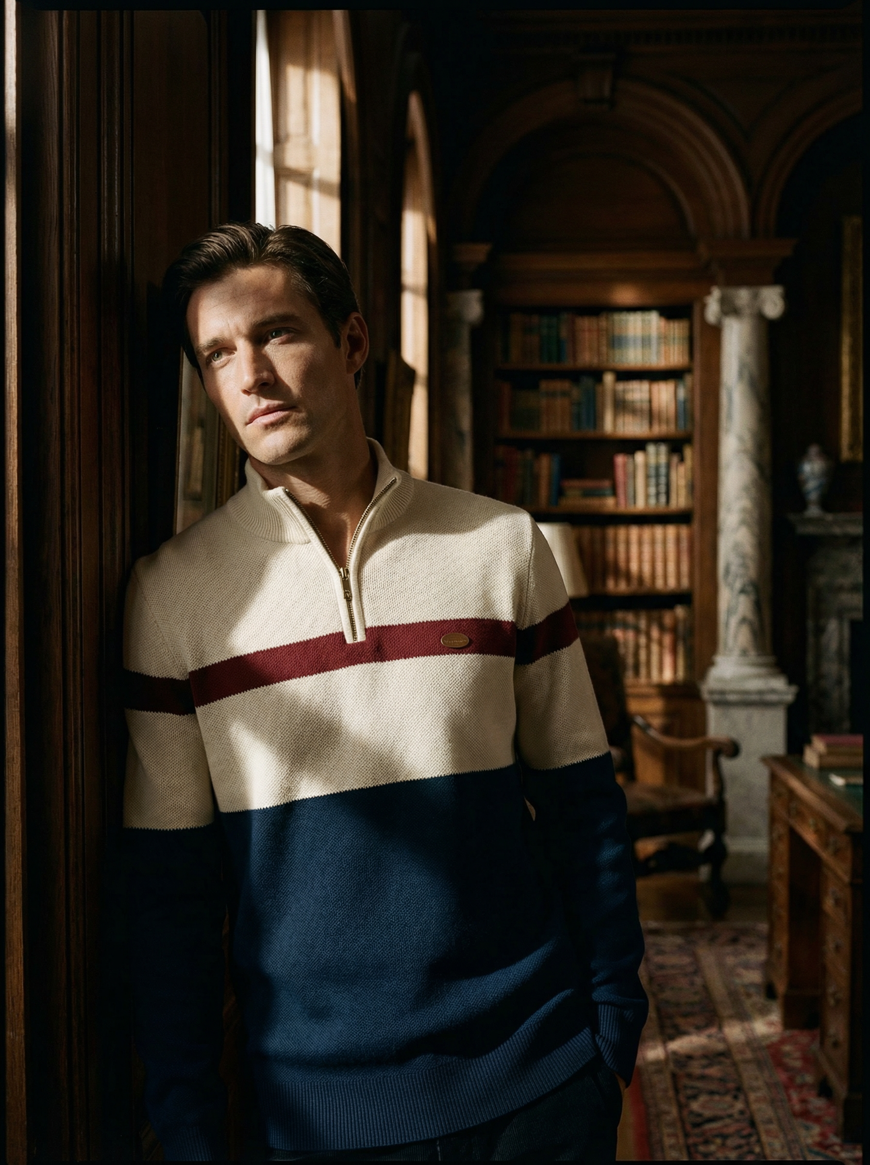 Man wearing a striped sweater in a library setting