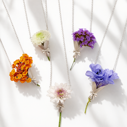 Five floral necklaces with different colored flowers on a white background