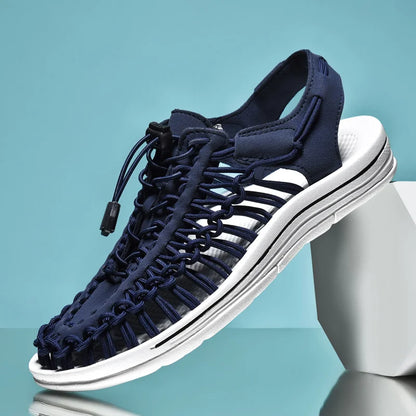 Navy sandal with white sole on a light blue background