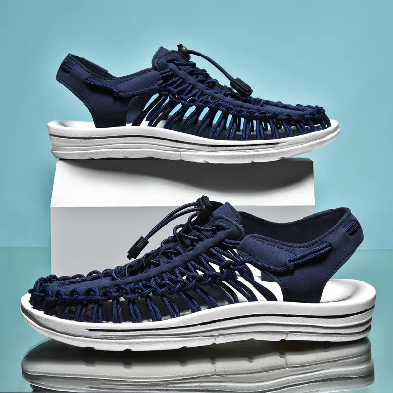 Navy sandals with white soles on a light blue background
