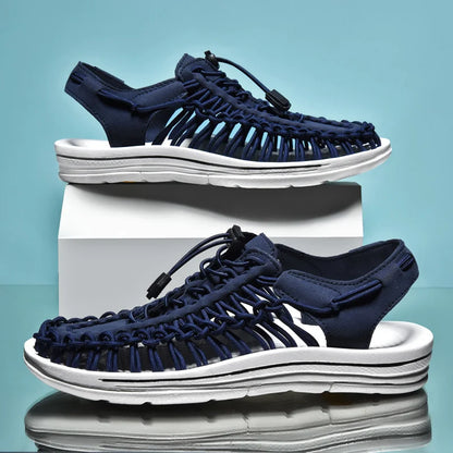 Navy sandals with white soles on a light blue background
