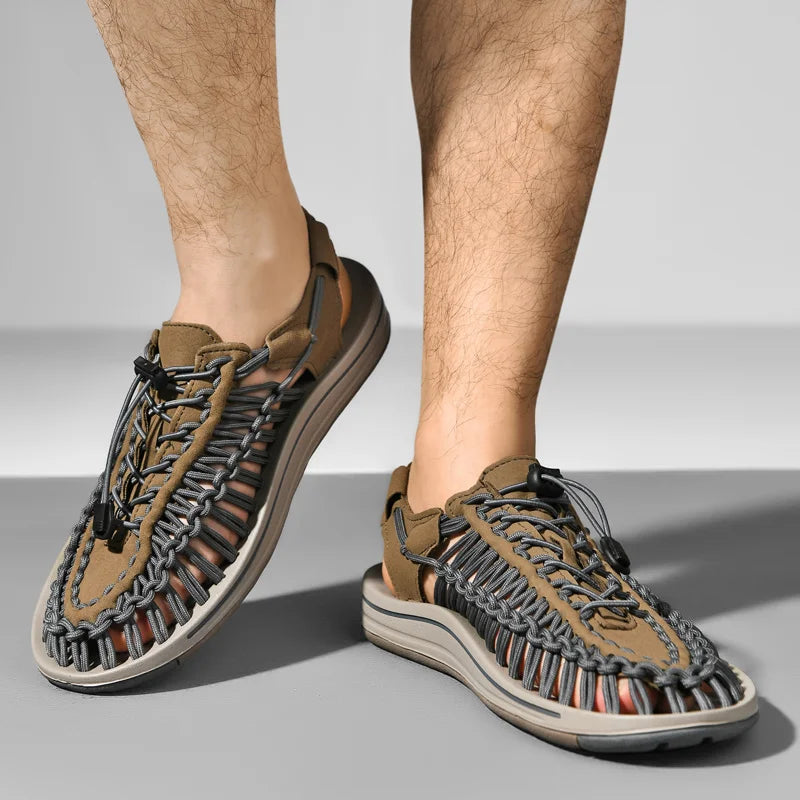Brown sandals with unique sole design worn by a person on a gray background