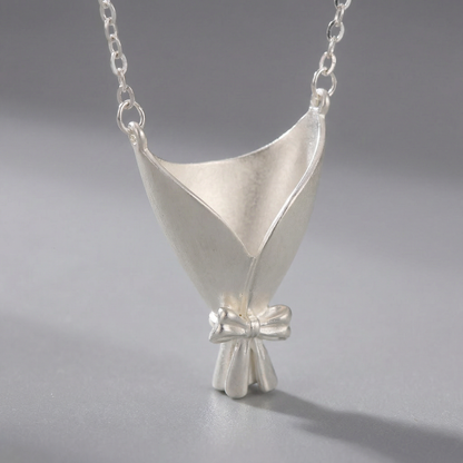 Silver pendant necklace on a gray background