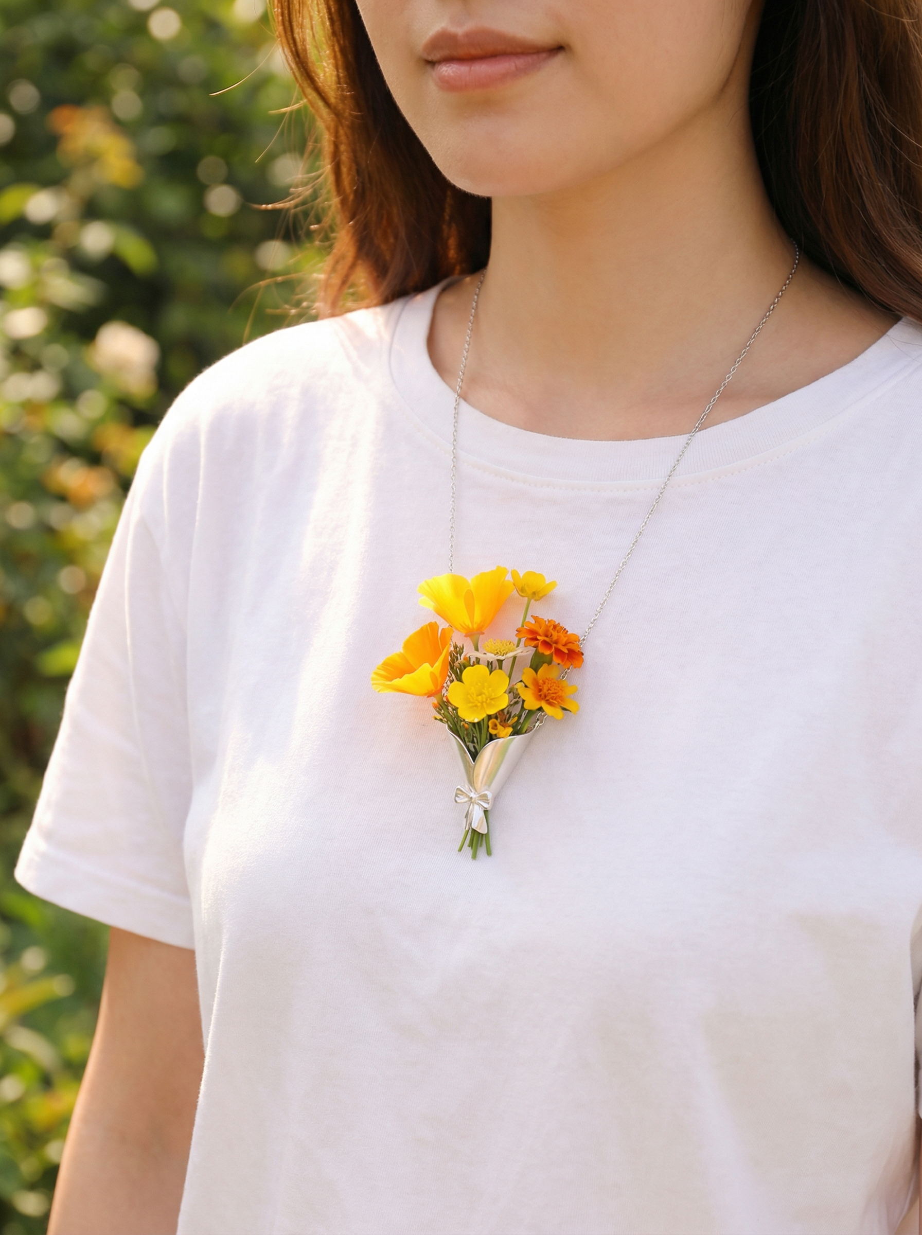 Person wearing a white shirt with a yellow flower bouquet pinned to it, outdoors.