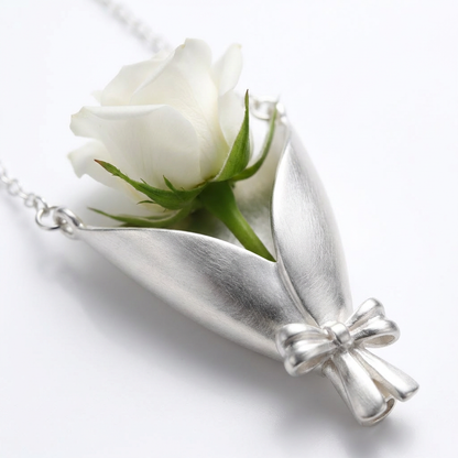 Silver pendant with a white rose on a white background