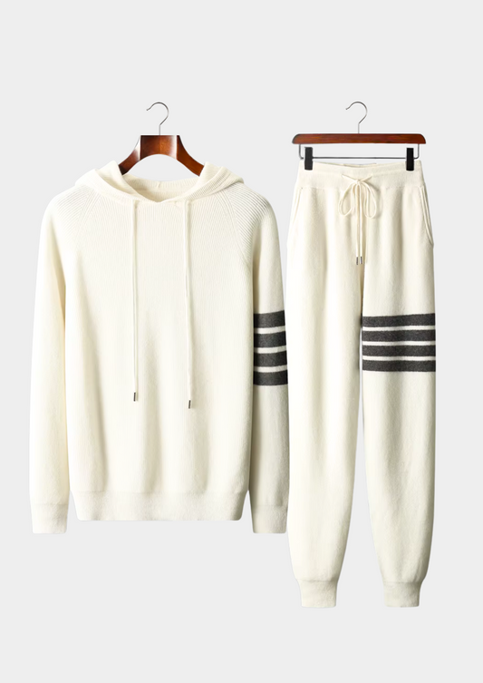 White hoodie and jogger pants set with black stripes on hangers against a white background