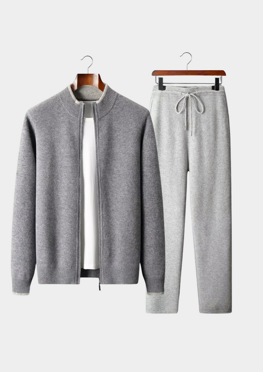 Gray cardigan and pants set on hangers against a white background