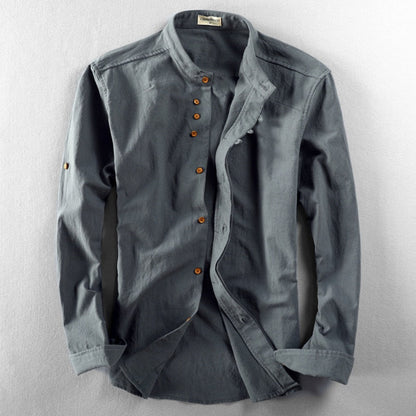Gray shirt with rolled-up sleeves on a light gray background