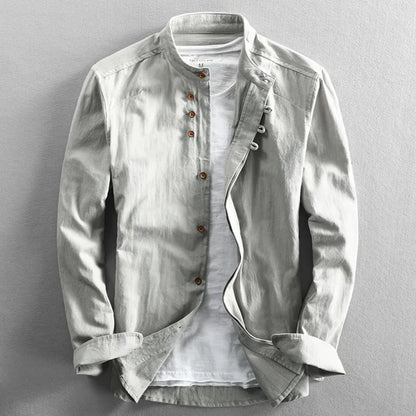 Light gray jacket over a white shirt on a gray background