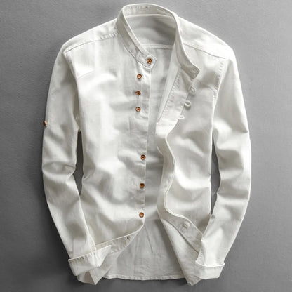 White denim shirt with brown buttons on a gray background