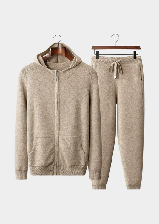 Beige hoodie and jogger pants set on hangers against a white background