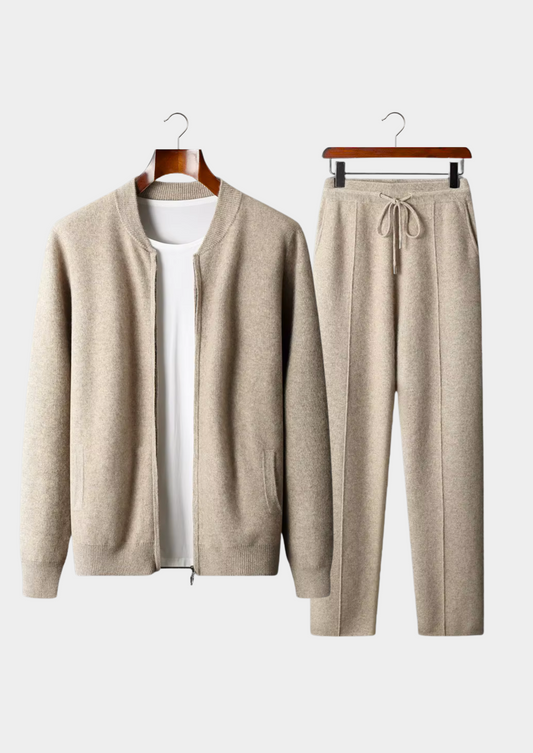 Beige cardigan and pants set on hangers against a white background