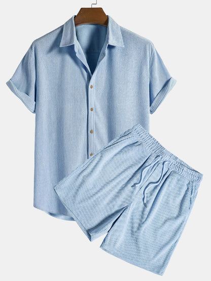 Blue striped shirt and shorts set on a hanger against a white background