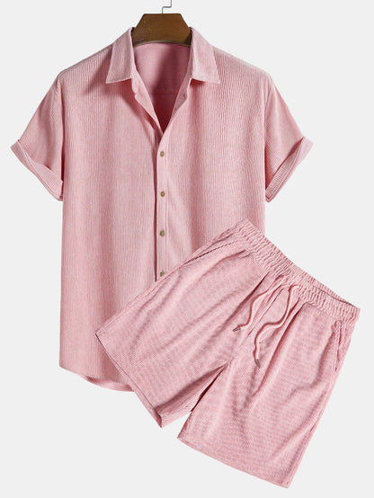 Pink striped shirt and shorts set on a hanger against a white background