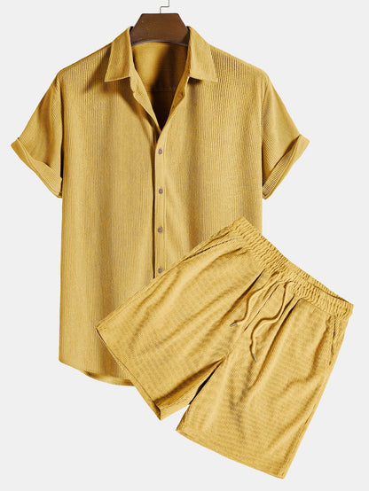 Yellow shirt and shorts set on a hanger with a white background