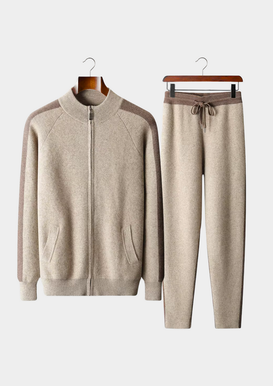 Beige tracksuit with a jacket and pants on hangers against a white background