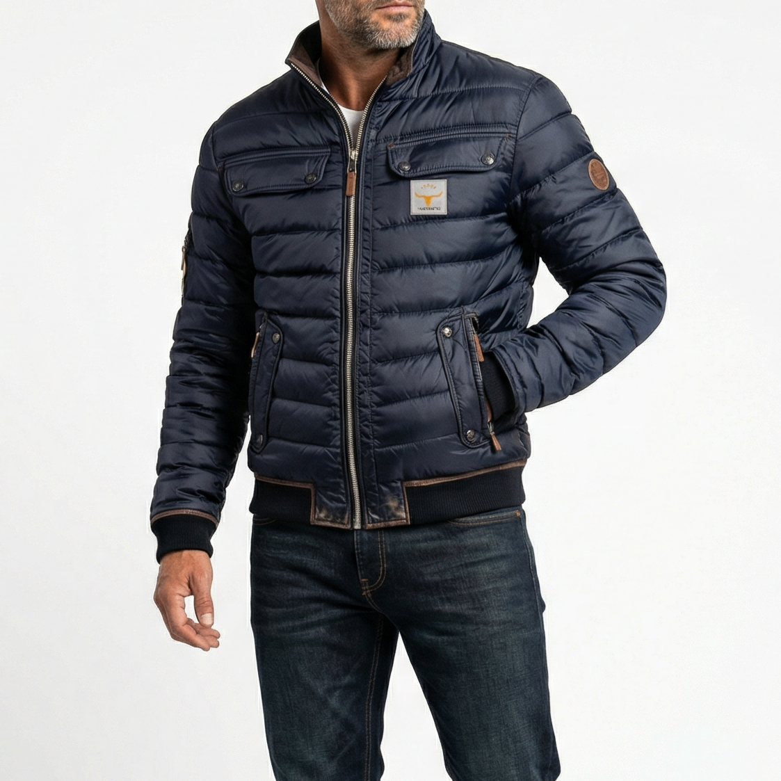 Man wearing a navy blue puffer jacket with a brand logo on a white background