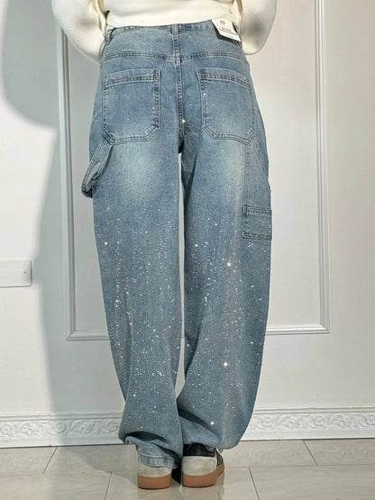 Person wearing light blue jeans with a white background