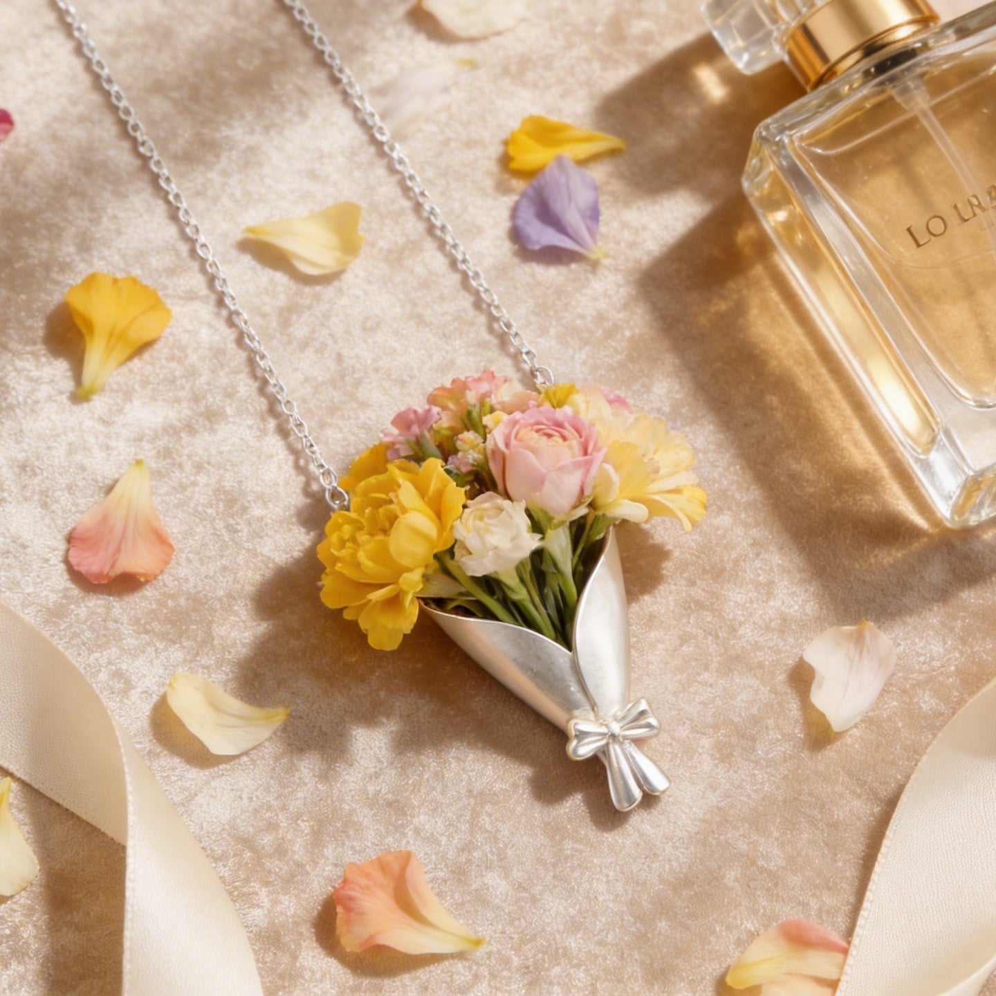 Perfume bottle with flowers and ribbons on a textured surface