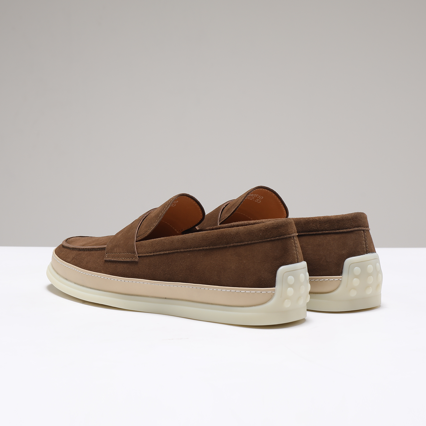 Brown suede loafer heel grip detail with dotted rubber heel