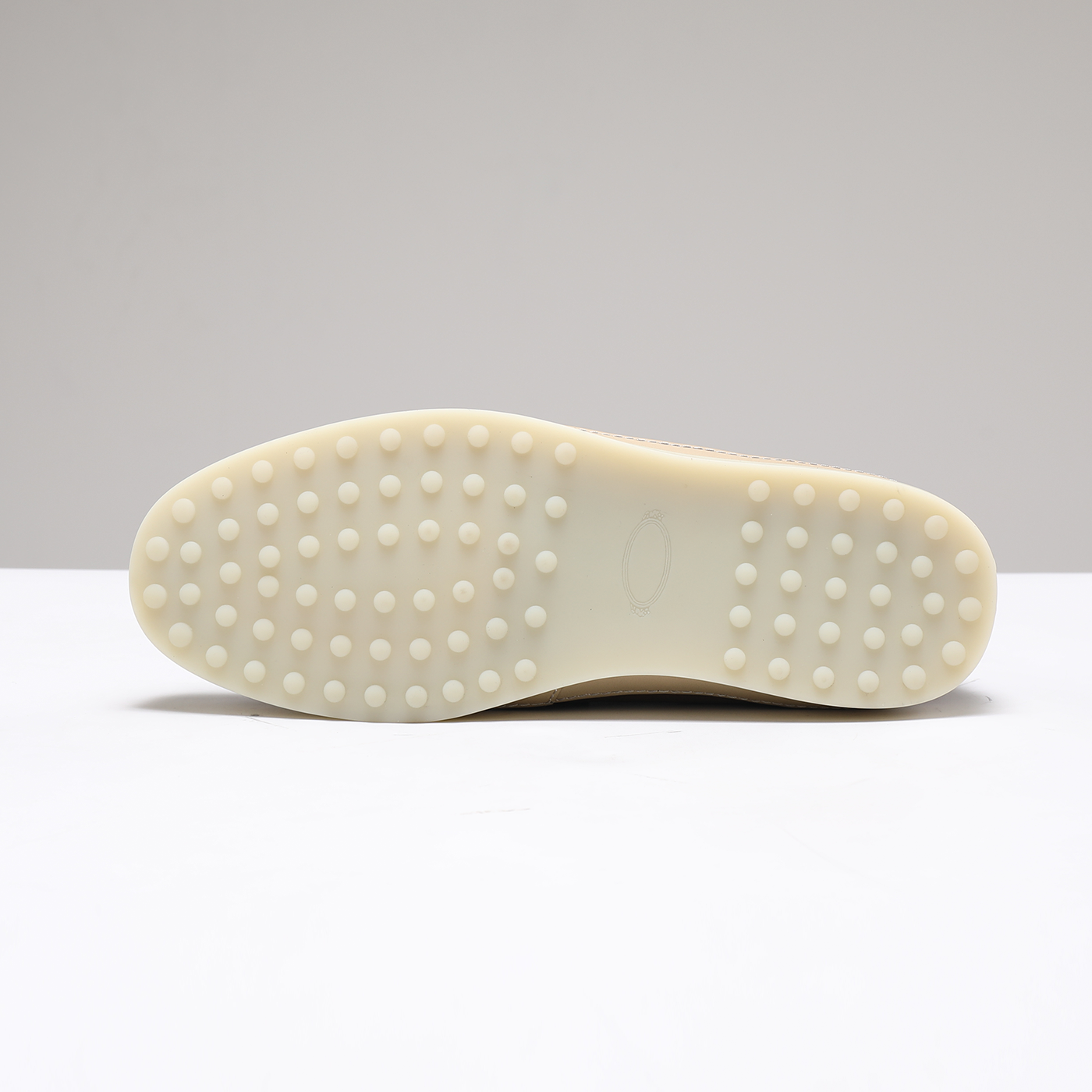 Cream dotted rubber driving sole on men’s brown suede loafers