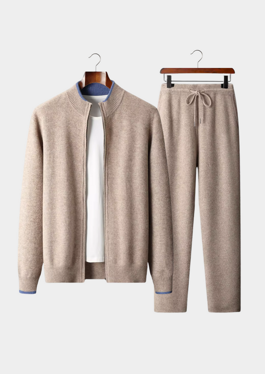 Beige cardigan and pants set on hangers against a white background