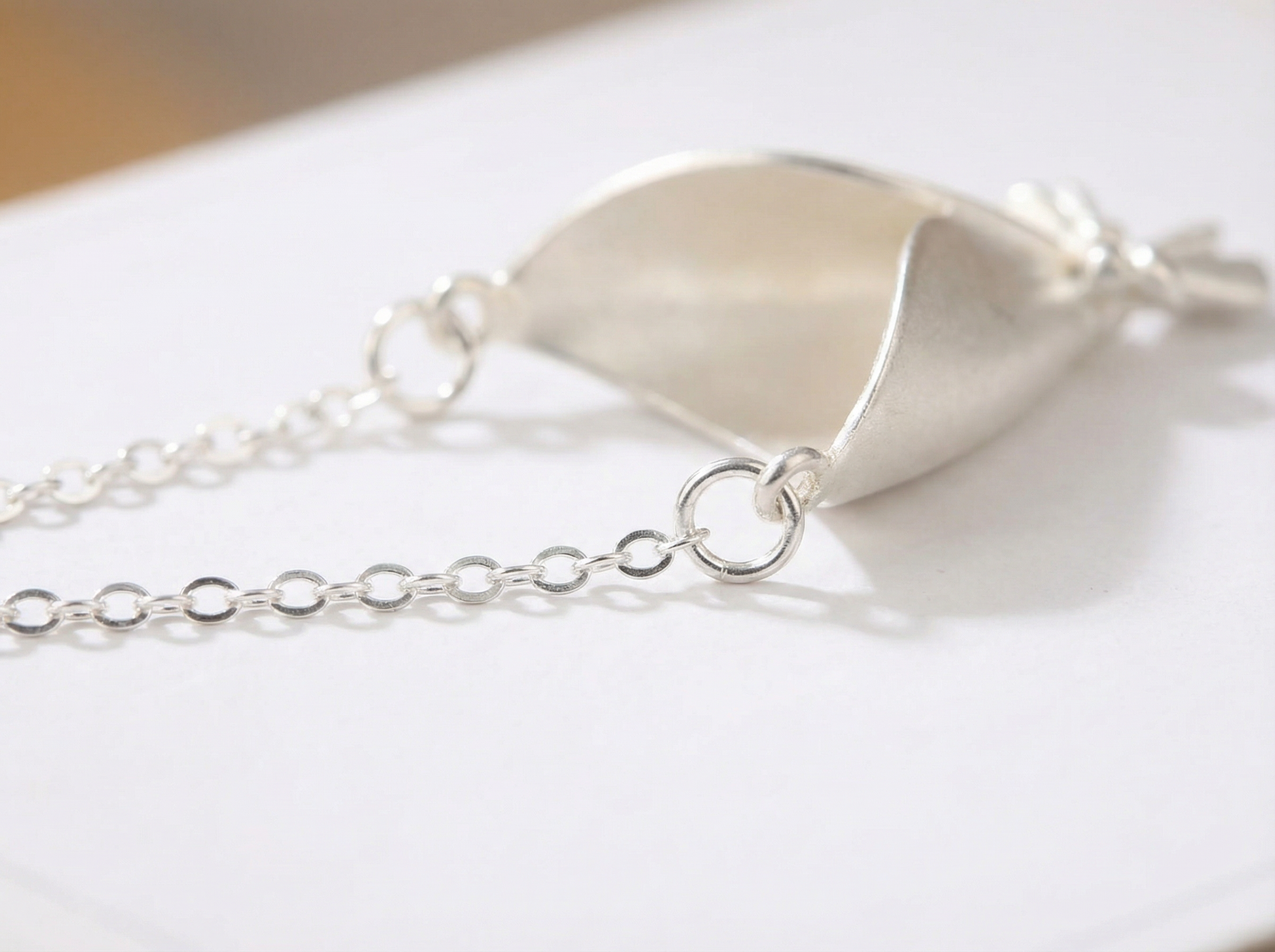 Silver bracelet with a unique design on a white surface