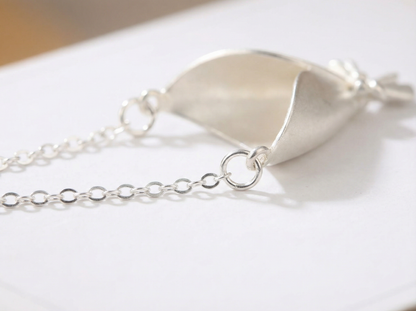 Silver bracelet with a unique design on a white surface