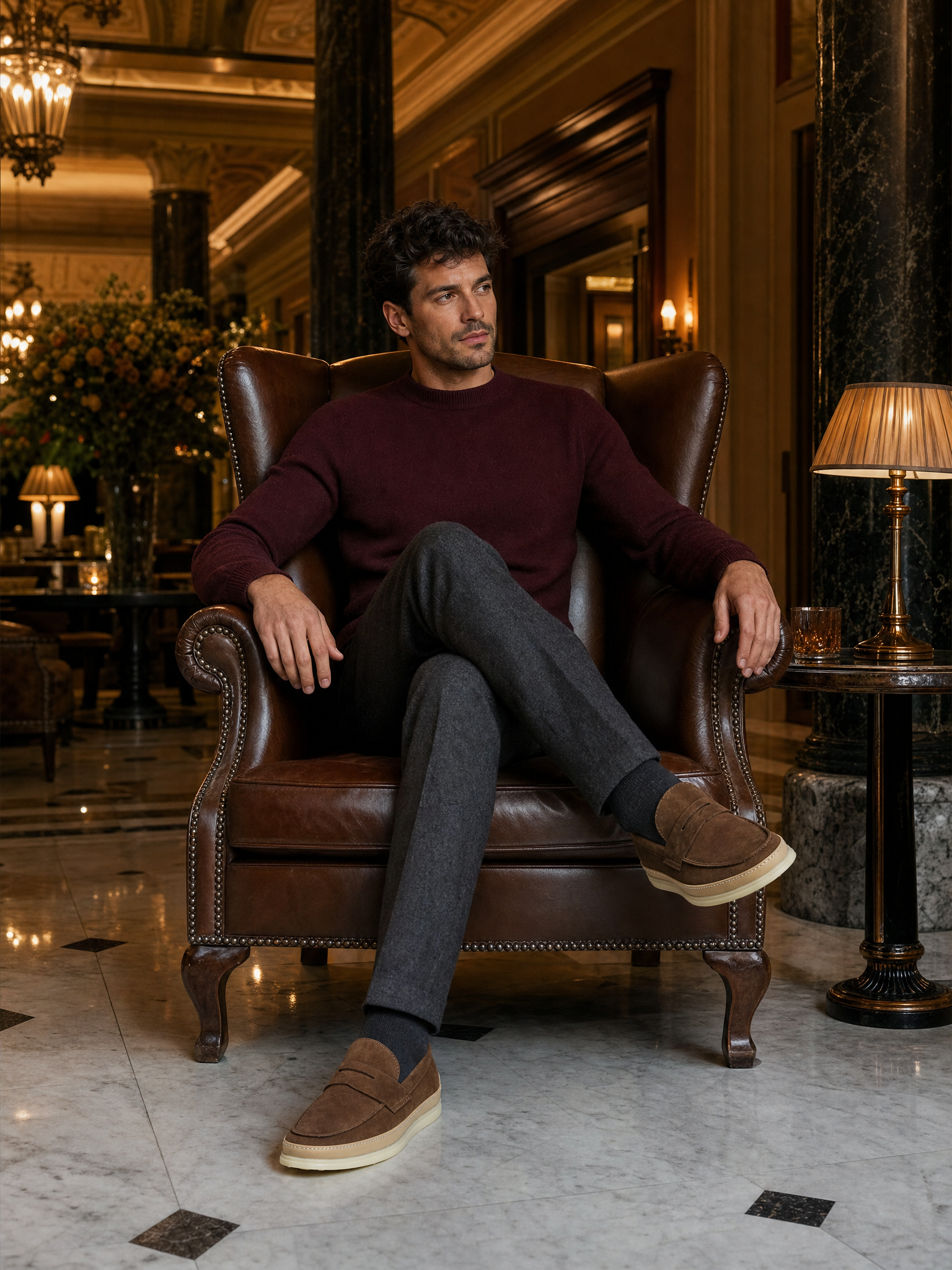 Brown suede loafers styled in a hotel lounge setting
