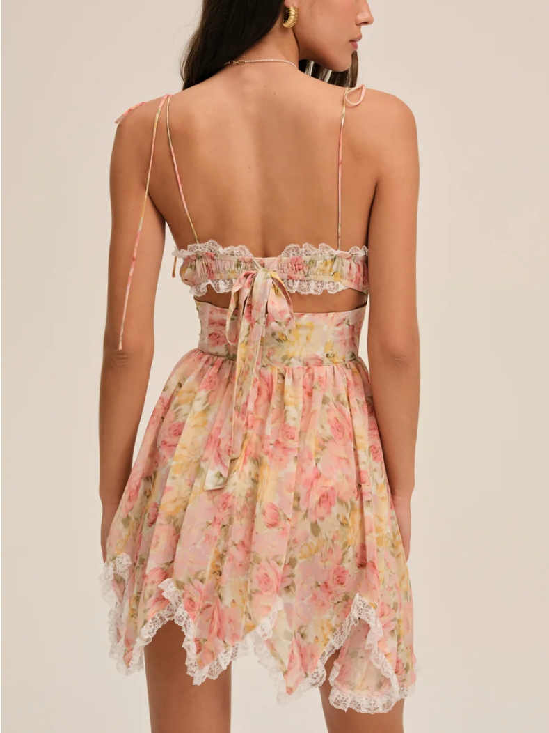 Woman wearing a floral dress with lace details on a beige background