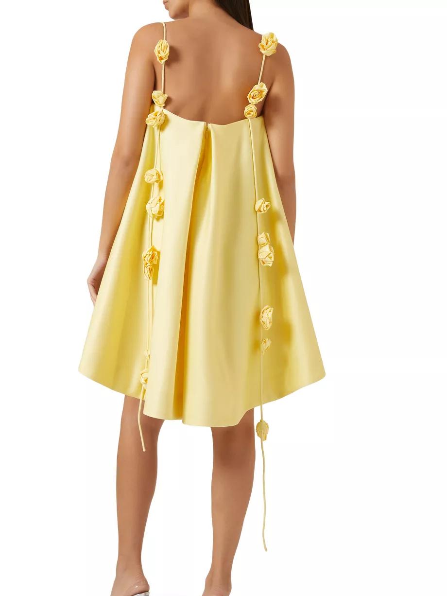 Yellow dress with floral straps on a white background