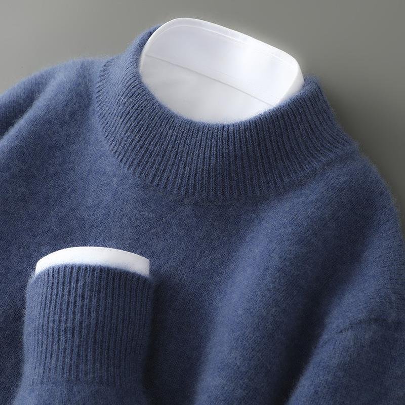 Close-up of a blue sweater on a mannequin against a gray background