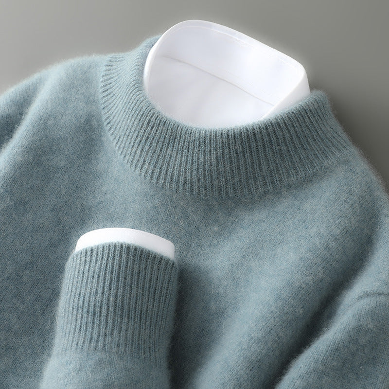 Light blue sweater with white cuffs and hem on a gray background