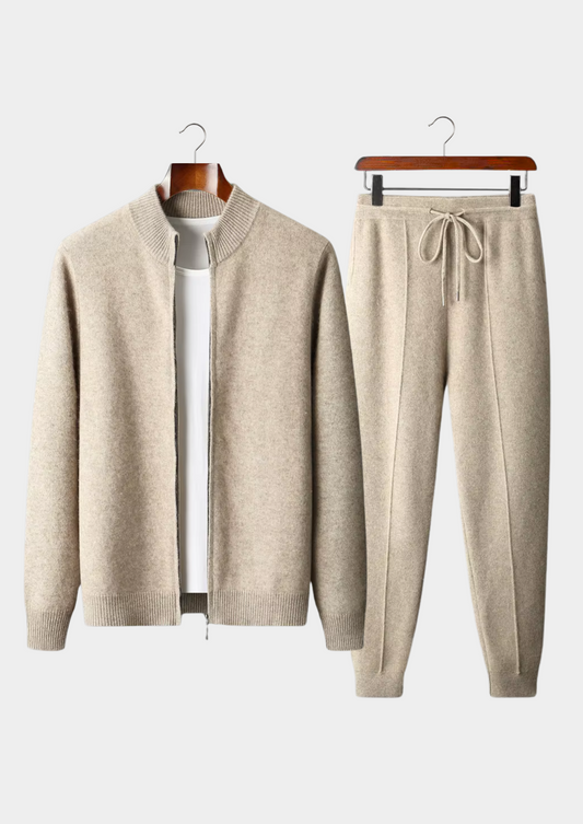 Beige cardigan and jogger pants set on hangers against a white background