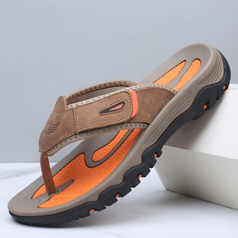 Brown and orange sandal with black sole on a light gray background