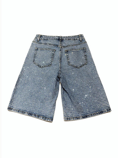 Blue denim shorts with a subtle pattern on a white background