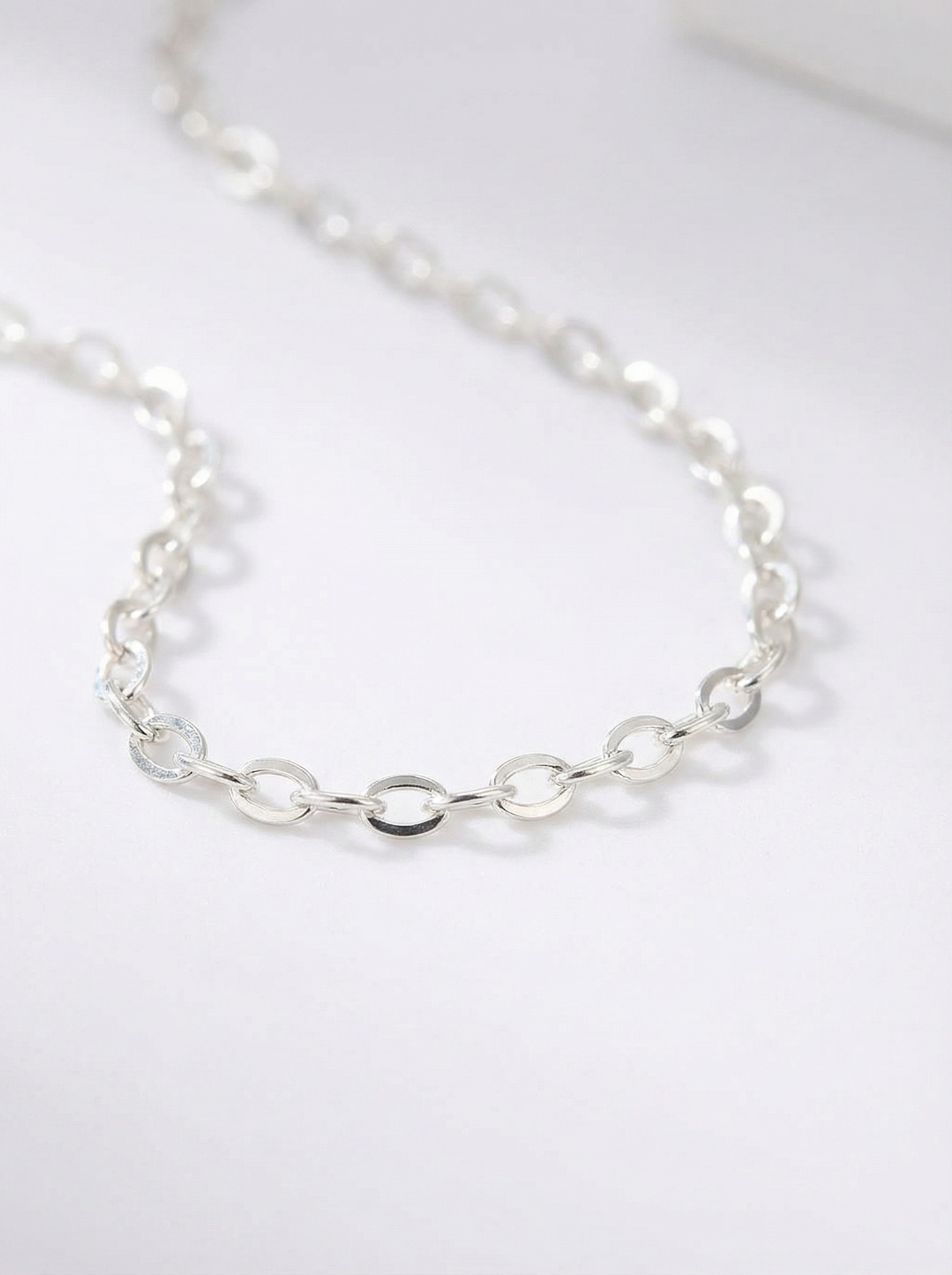 Silver chain necklace on a white background